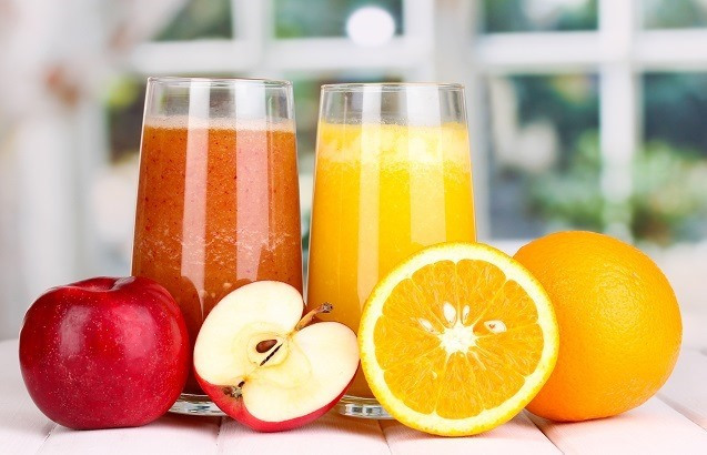fresh fruit juices on wooden table, on window background